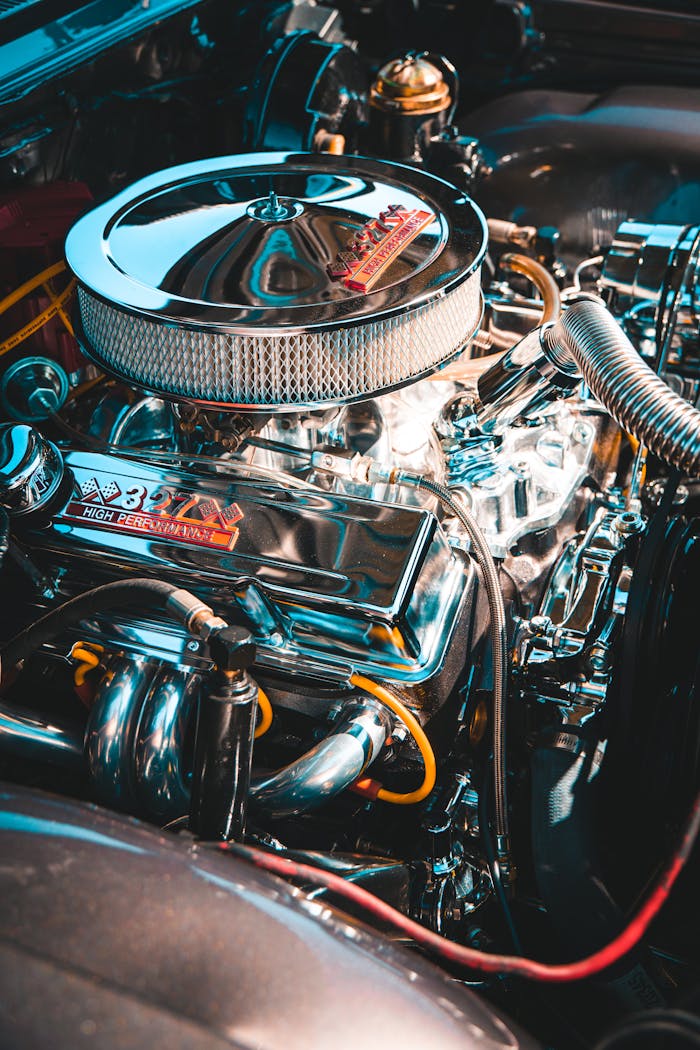 Detailed close-up of a vintage car engine showcasing chrome components and filter.